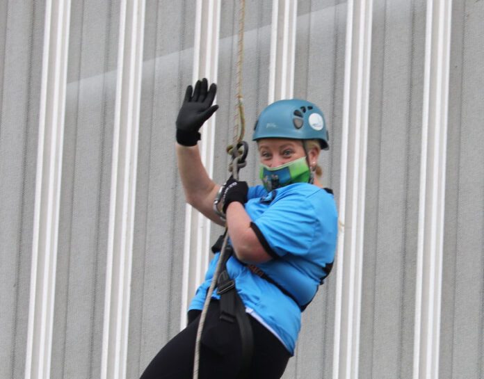 Cllr Sarah Kiely abseiling down the side of Thomond Park.