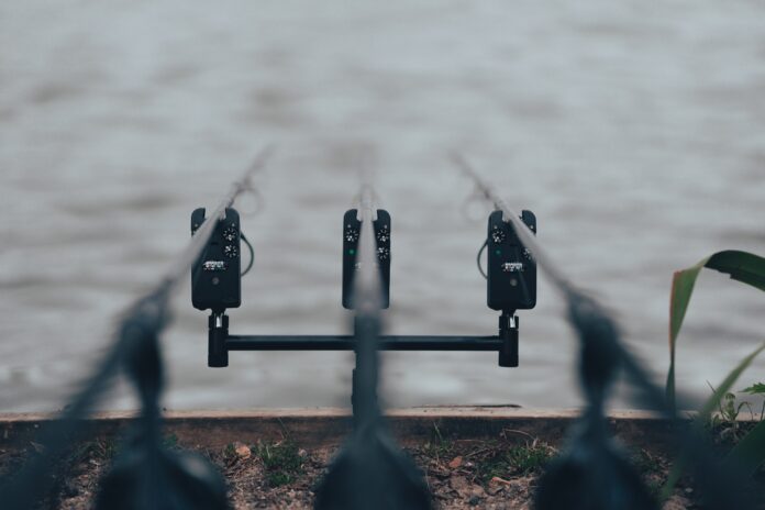 black metal padlock on black metal fence