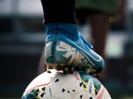 white and blue soccer ball on green grass field