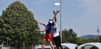 man in blue and white jersey shirt and black shorts playing soccer during daytime