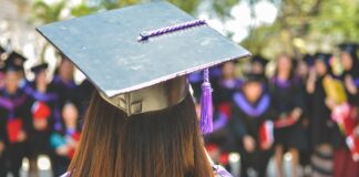 woman wearing academic cap and dress selective focus photography