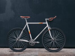 gray fixie bike leaning on black wall
