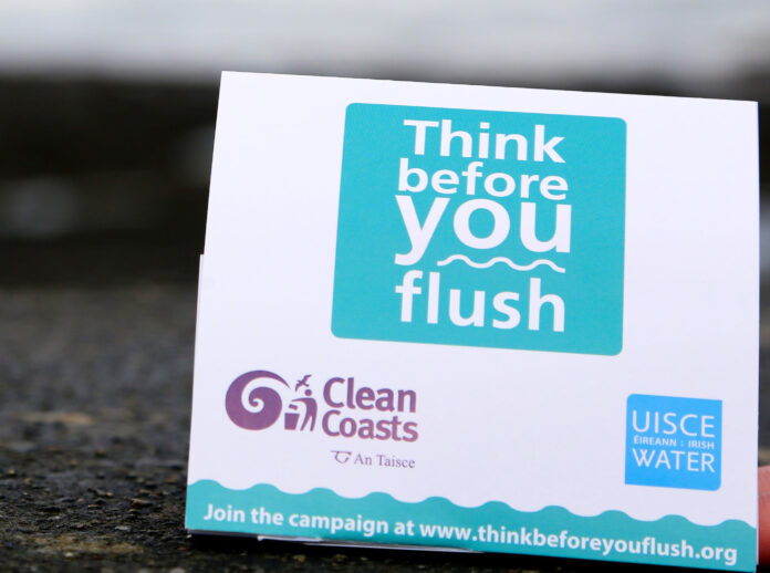A tent card for display on toilets as a reminder to Think Before