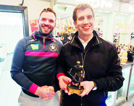 Cian Madden receiving his Man of the Match trophy from Brian Casey.