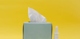 white and brown bottle beside white tissue box