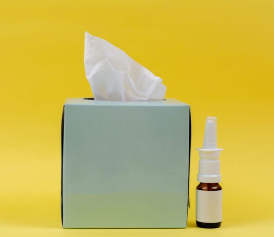 white and brown bottle beside white tissue box