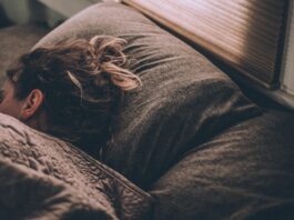 woman sleeping on bed under blankets