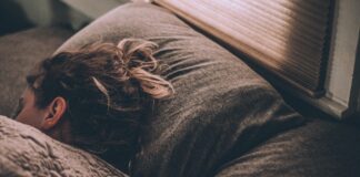 woman sleeping on bed under blankets