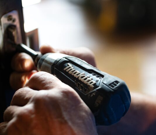 selective focus photography blue and black Makita power drill
