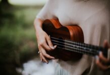 woman playing ukulele at daytime