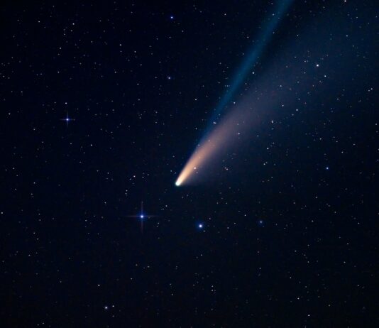 a comet is seen in the night sky