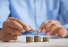 a person stacking coins on top of a table