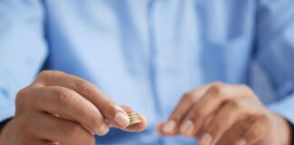 a person stacking coins on top of a table