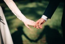 man and woman holding hands focus photo