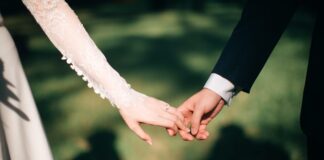 man and woman holding hands focus photo