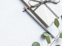 flat lay photo of book and pencil
