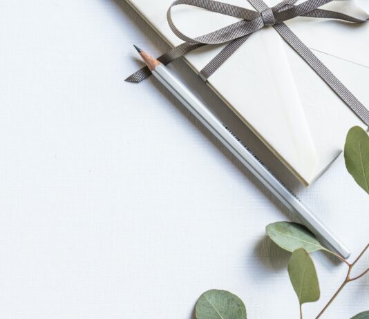 flat lay photo of book and pencil