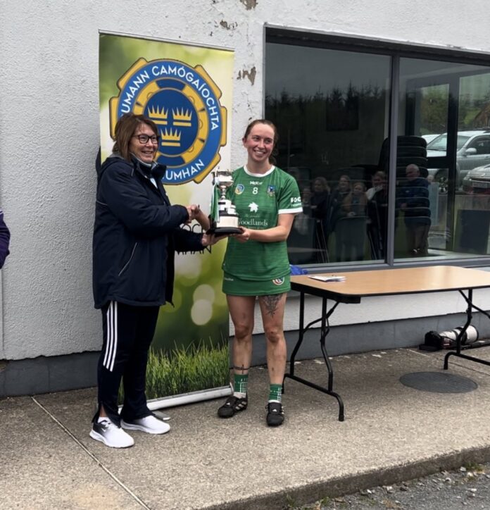 Marian Graham of Munster Camogie presents the Burns Perpetual Cup to Limerick captain Ann Kennedy.
