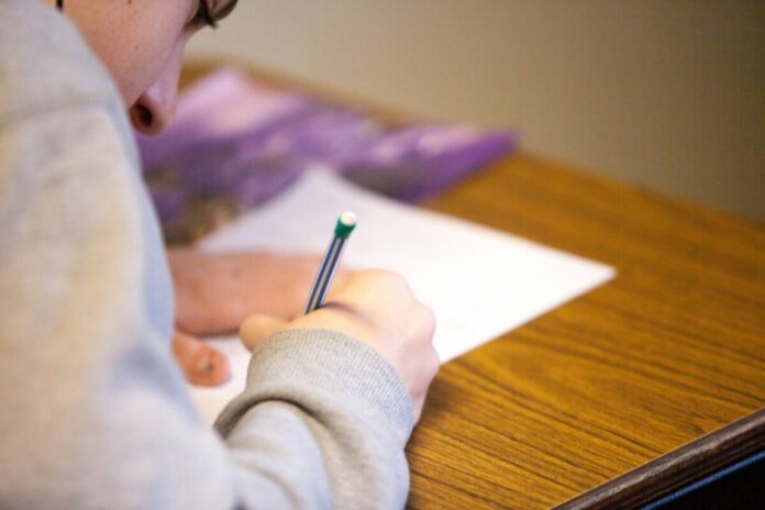 ben-mullins-oXV3bzR7jxI-unsplash education exam school desk leaving cert junior class classroom